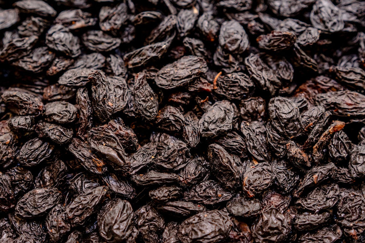 High-quality close-up image of a pile of dried raisins perfect for health-focused content.
